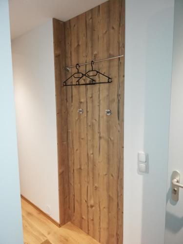 a wooden door in a room with a wall at Ferienwohnung mit Aussicht auf die Burg in Wertheim
