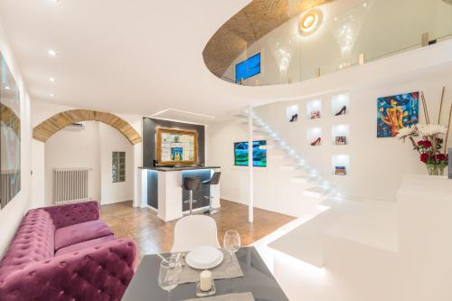 a living room with a purple couch and a staircase at Budapest Presidential in Budapest