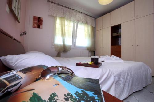 a bedroom with two beds and a laptop on a table at Sofias Ferienhaus in Kavala