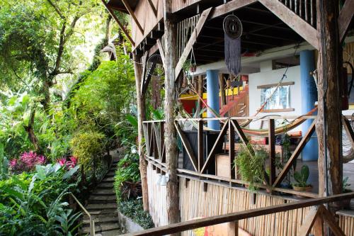 a house with a staircase leading to a garden at Hostel Plinio in Manuel Antonio