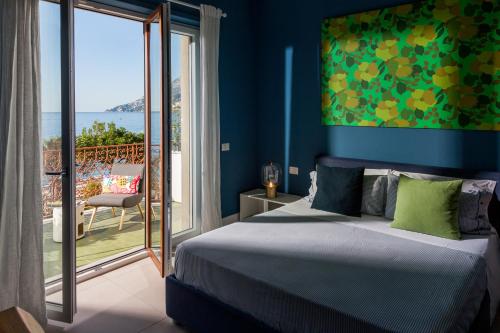 a bedroom with a bed and a view of the ocean at B&b Don Giovanni in Maiori