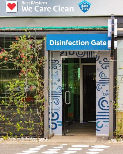 an entrance to a building with a sign that reads destination gate at Best Western Hotel Galla in Pristina