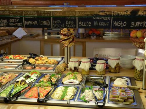 a buffet filled with lots of different types of food at Hotel Bambi Boutique in Zakopane