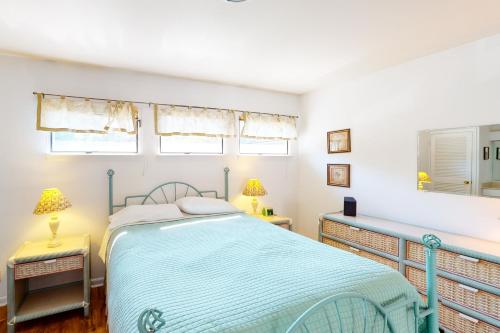 a bedroom with a bed and two lamps and windows at Sea Colony - 4003 Volley in Bethany Beach
