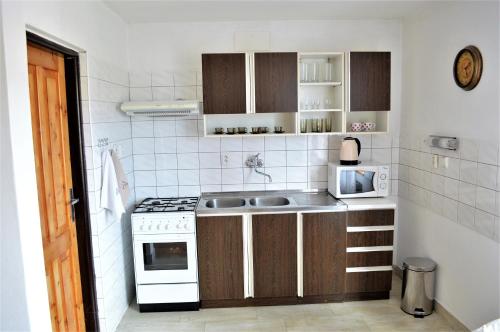 a small kitchen with a sink and a stove at Apartmány LÍVIA Litmanová in Litmanová