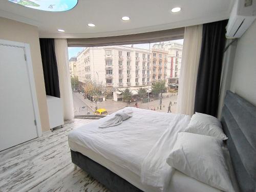 a bedroom with a bed and a large window at King Istanbul Hotel in Istanbul