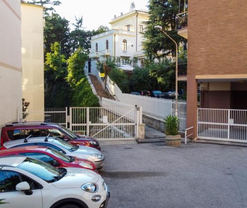 a row of parked cars parked in a parking lot at Relais Villa Montedonzelli in Naples