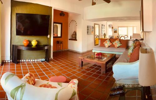 a living room with two couches and a fireplace at Departamento en Marina Vallarta New listing in Puerto Vallarta