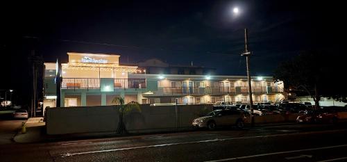 a building with cars parked in front of it at night at Beachwalker Inn & Suites in Pismo Beach