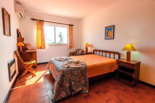 a bedroom with a bed and a table in it at Villa 300m from Beach - By Algarkasa in Albufeira