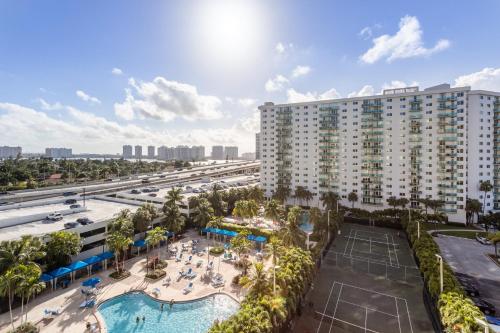 an aerial view of a resort with a pool and a tennis court at Sunny Isles Ocean Reserve Superb Condo Apartments in Miami Beach