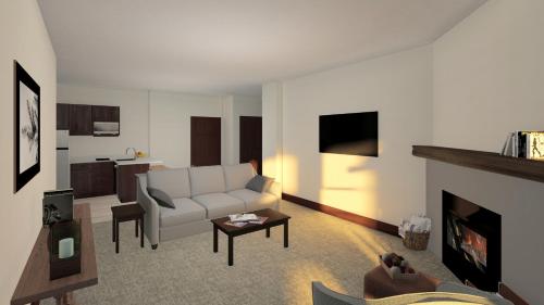 a living room with a white couch and a fireplace at Corduroy Inn and Lodge, Trademark Collection by Wyndham in Snowshoe