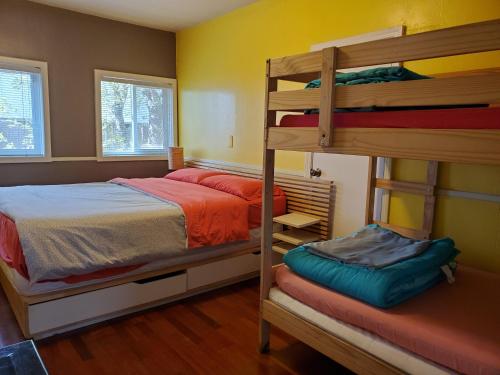 a bedroom with two bunk beds and a ladder at Yosemite International Hostel in Groveland