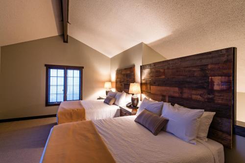 a hotel room with two beds and a window at Corduroy Inn and Lodge, Trademark Collection by Wyndham in Snowshoe