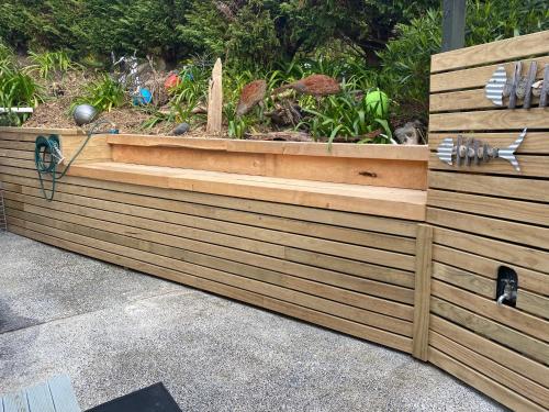 a wooden planter box with a garden in it at Pacific Harbour Lodge in Whangaroa