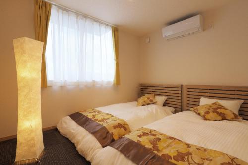 Postel nebo postele na pokoji v ubytování Villas Asama no Iori