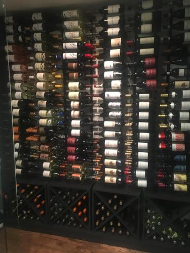 a wall of wine bottles in a wine cellar at Corduroy Inn and Lodge, Trademark Collection by Wyndham in Snowshoe