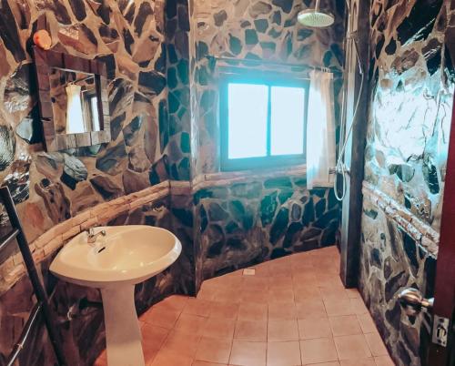 a bathroom with a sink and a window at High Life Bungalow in Haad Yao