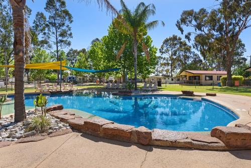 a pool with a pool table and chairs in it at Discovery Parks - Moama West in Moama
