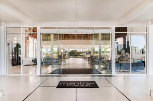 a living room with a large glass door at Mantra on Salt Beach in Kingscliff