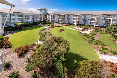 an aerial view of an apartment complex with a golf course at Mantra on Salt Beach in Kingscliff