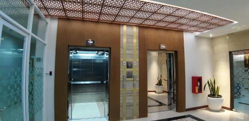 a hallway with a glass door in a building at Apartemen Taman Melati Yogyakarta by ArFe Room in Yogyakarta