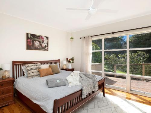 a bedroom with a bed and a large window at Newbury Haven in Penrose