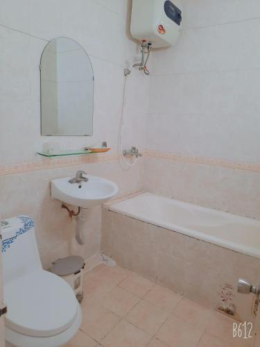 a bathroom with a sink and a toilet and a bath tub at Hanoi Carina Hotel in Hanoi