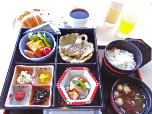 a tray filled with different types of food at Hotel Pearl City Kesennuma in Kesennuma