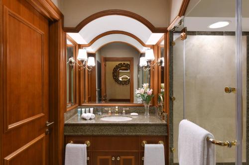 a bathroom with a sink and a shower at Al Aziziyah Boutique Hotel By The Torch in Doha