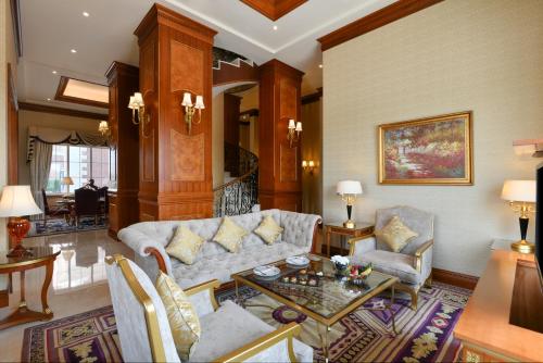 a living room with a couch and a table at Al Aziziyah Boutique Hotel By The Torch in Doha