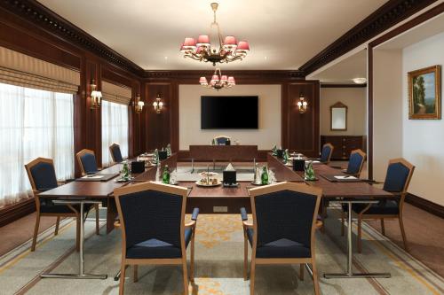 a conference room with a large table and chairs at Al Aziziyah Boutique Hotel By The Torch in Doha