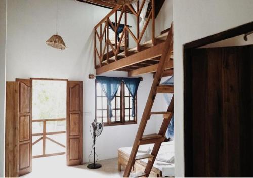 a room with two bunk beds and a window at Surfpoint Sri Lanka Kite Village in Kalpitiya