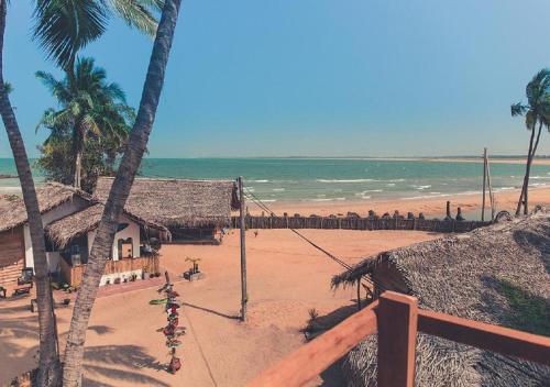 a view of a beach with houses and the ocean at Surfpoint Sri Lanka Kite Village in Kalpitiya