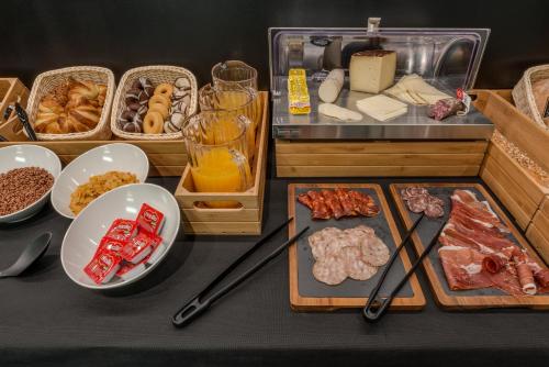 a table with a bunch of food on it at Hotel Olot Centre in Olot