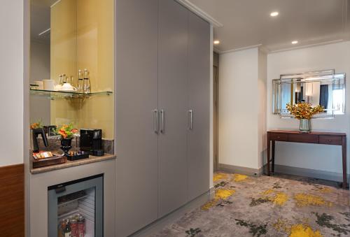 a kitchen with white cabinets and a fireplace at The Artisan Hotel Istanbul - MGallery Collection in Istanbul