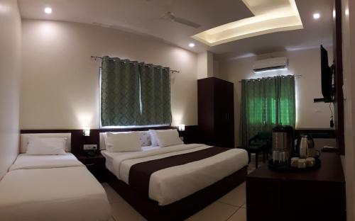 Katil atau katil-katil dalam bilik di Hotel Paradise inn