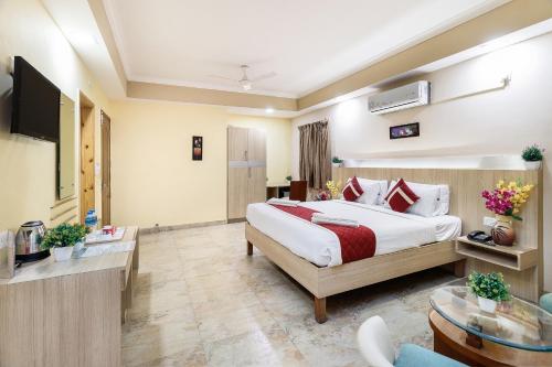 a hotel room with a bed and a living room at Octave Royal Opera in Bengaluru