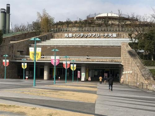 a large building with people walking in front of it at GUEST HOUSE APPLE in Osaka