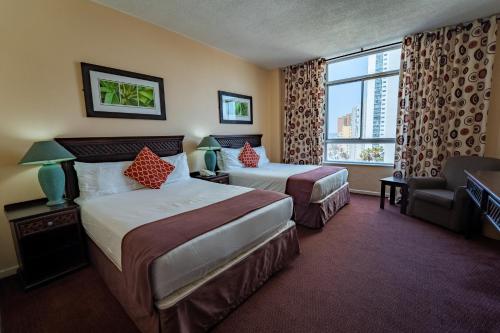 Postel nebo postele na pokoji v ubytování Gooderson Tropicana Hotel