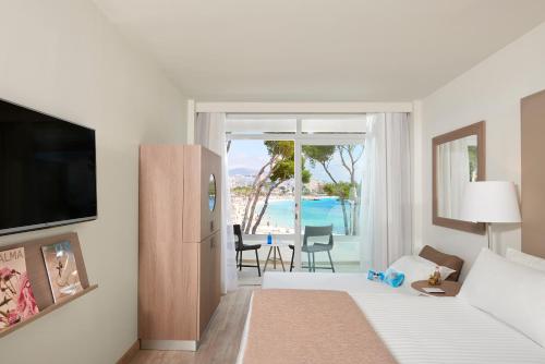 a hotel room with a bed and a view of the ocean at Meliá Calviá Beach in Magaluf