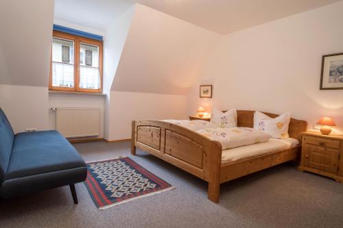 a bedroom with a bed and a couch and a chair at Apfelblüte in Lindau
