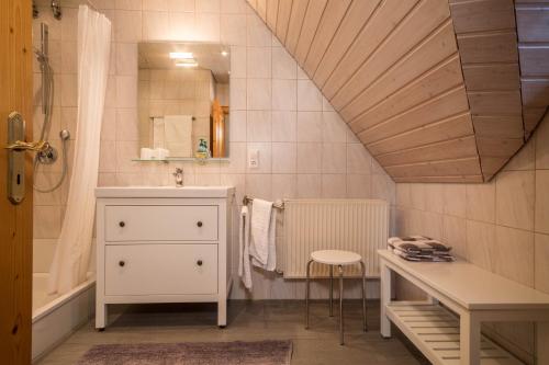 a bathroom with a sink and a vanity and a tub at Apfelblüte in Lindau