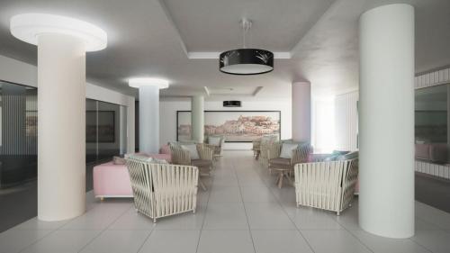 a living room filled with furniture and a tv at Hotel Garbi Ibiza & Spa in Playa d'en Bossa