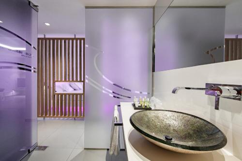 a bathroom with a sink and a bath tub at Hotel Garbi Ibiza & Spa in Playa d'en Bossa