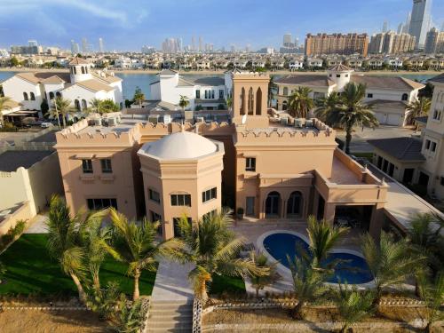 an aerial view of a house with palm trees at Villa Casablanca- Exclusive 7-Bedroom Villa with Signature Amenities By Luxury Explorers' Collection in Dubai