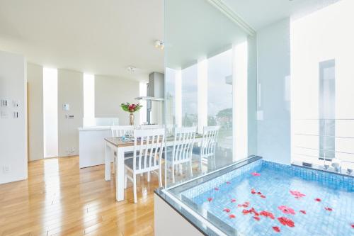 a kitchen and dining room with a swimming pool at RIZOZAIZEN MOTOBU B in Motobu