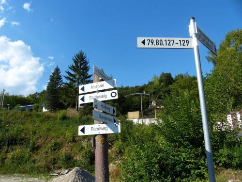a street sign with many signs on a pole at Ferienhaus Frankenglueck in Egloffstein
