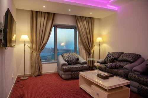 a living room with a couch and a chair at Jazan Inn Hotel in Jazan