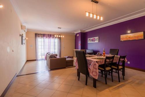 a dining room with a table and a purple wall at Sergio s Place - FARM VILLAGE - By Algarkasa in Albufeira